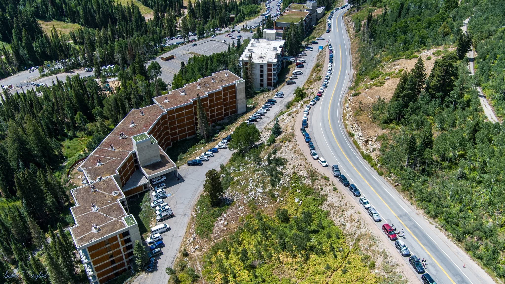 Aerial view of traffic and roadside parking along SR-210 in Little Cottonwood Canyon near Snowbird during a busy Oktoberfest weekend.